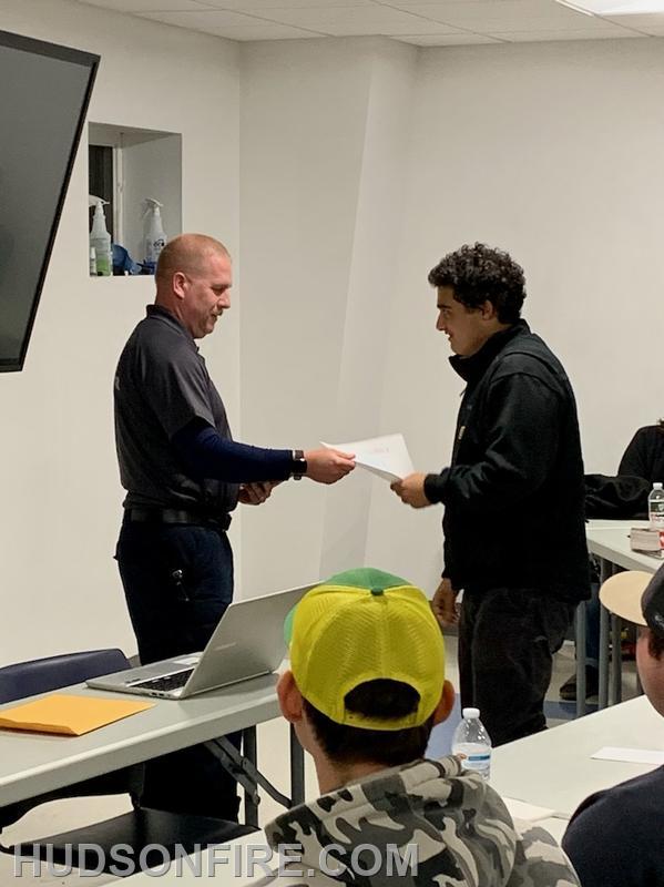 Firefighter Miles Goldfarb being presented his certification by New York State Fire Instructor Daniel Hickey Jr., who is also a City of Hudson Firefighter and past Captain.